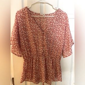 Large pink Sienna Sky cinch waist top.